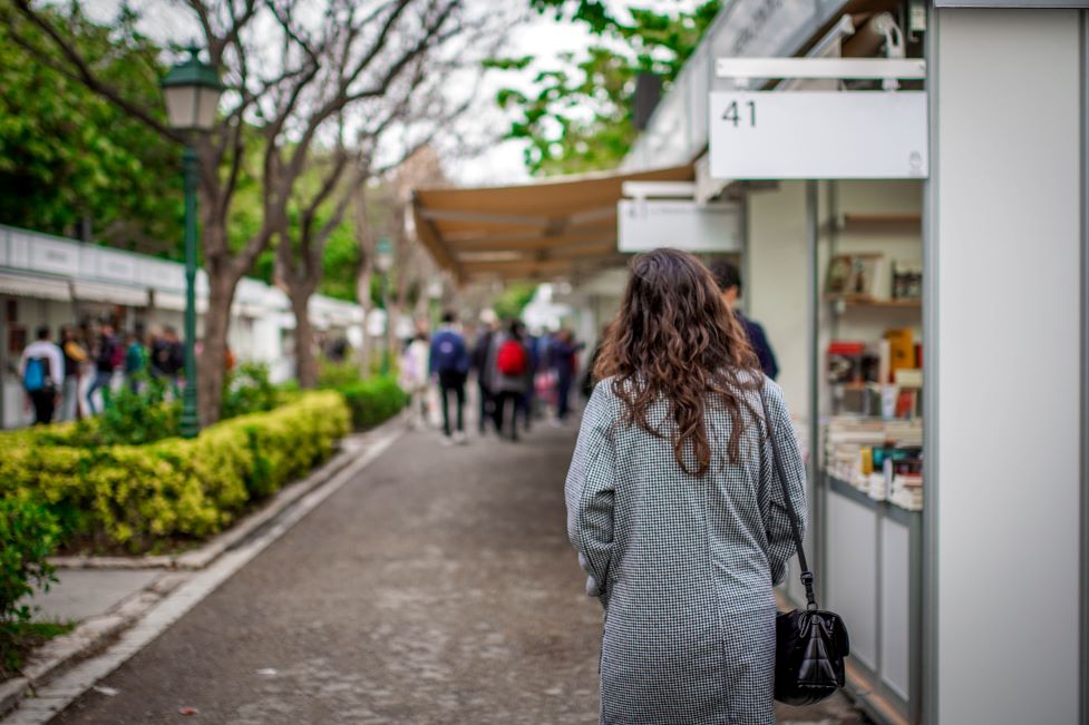 A woman walking in an outdoors book fair in Miami